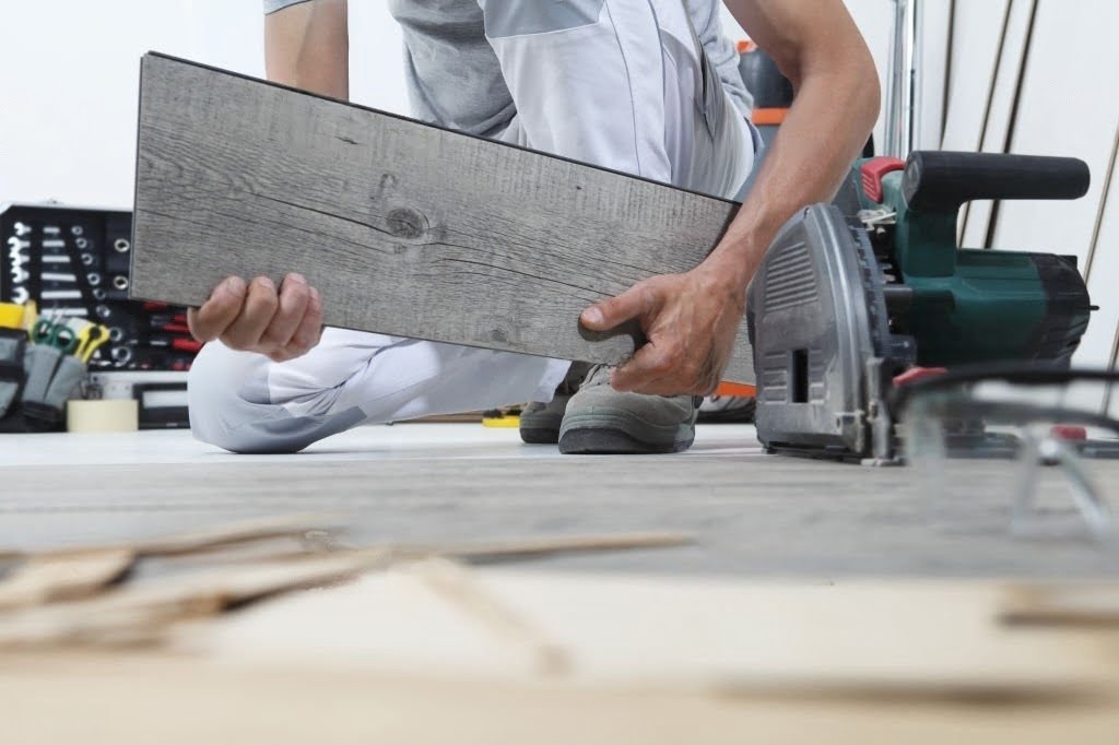 person cutting laminte flooring circular saw